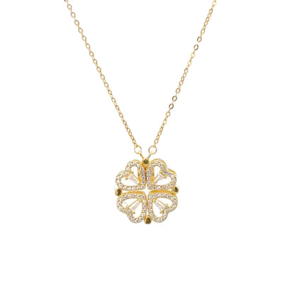 gold layered necklace — one chain with a four-leaf clover pendant and the other with small heart-shaped pendants.